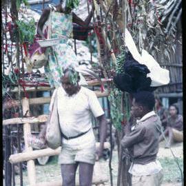 Man and Woman Descending from Elevated Platform in Village