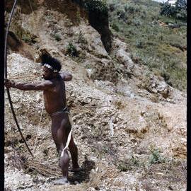 Man Posing with a Bow
