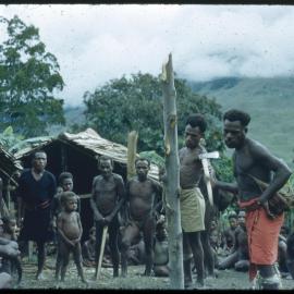 Group Gathered Around Pole