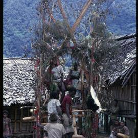 Couple Sitting on Elevated Platform in Village