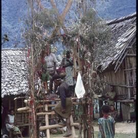 Couple Sitting on Elevated Platform in Village