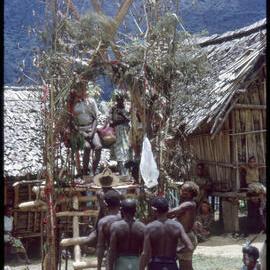 Couple Sitting on Elevated Platform in Village