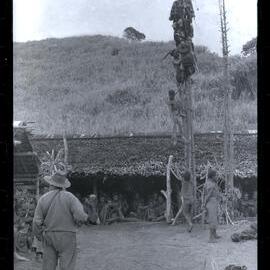 Men Climbing Food Pole