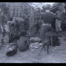 Men Preparing Bundles of Food