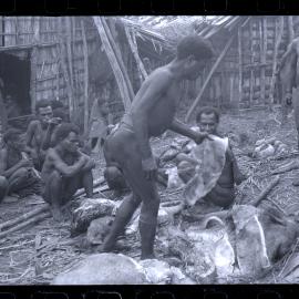 Group Preparing Pigs for a Ceremony