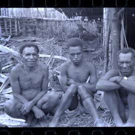 Men Sitting Outside a Building