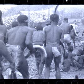 Men Carrying Meat Through a Village