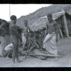 Men Preparing Pigs for a Ceremony