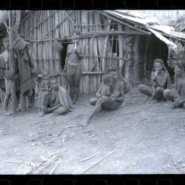 Women and Children Sitting Outside a Building