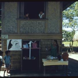 Women and Children Outside a Building