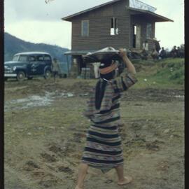 Girl Carrying a Basket on her Head
