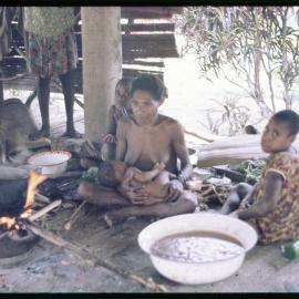 Women and Children Around Cooking Fire