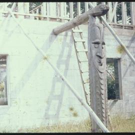 Carved Wooden Posts Attached to Building