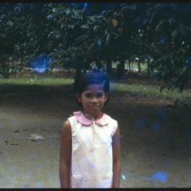 Girl Standing in Garden