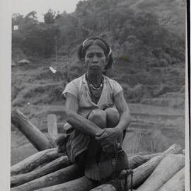 Woman Sitting on Logs