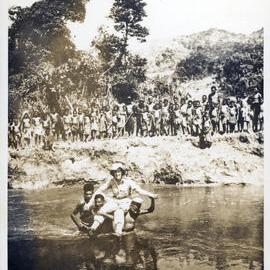 Woman Being Carried Across River, with Group Watching