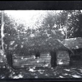 [Manum Island, New Guinea] Men on Top of the Roof Resting After Thatching