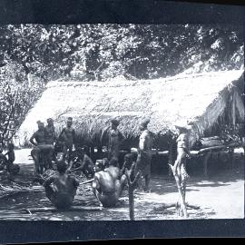[Manum Island, New Guinea] The Men Cutting up the Pig