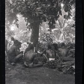 [Manum Island, New Guinea] The Men of Waia Sitting Round Cracking Galips