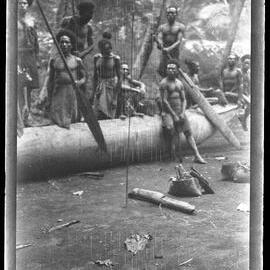 [Manum Island, New Guinea] Some Men of Yassa Visiting in Mamboti’s Homestead Display a Big Steering Paddle which they have Brought