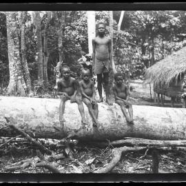 [Manum Island, New Guinea] Apui, Tsu’ua and Two Other Boys on the Felled Tree Outside CHW’s [Wedgwood] ouse