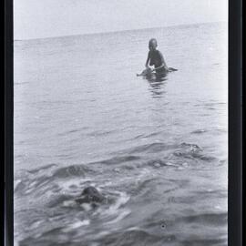 [Manum Island, New Guinea] Tsomoraua Washing Herself in the Sea with Leaves