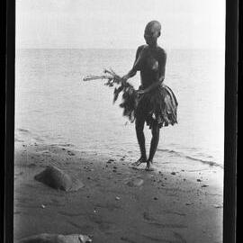 [Manum Island, New Guinea] Tsomoraua Coming out of the Sea with a Used Bunch of Leaves which she will Throw Away and get Some More