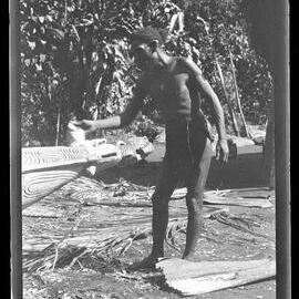 [Manum Island, New Guinea] Ruaŋatago Treating the Carved "Prow" at the Other End in the Same Way