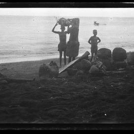 [Manum Island, New Guinea] Galip Nuts and Trays of Food in Leaf Bundles Waiting on the Beach to be Loaded onto the Canoes