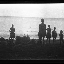 [Manum Island, New Guinea] Galip Nuts and Trays of Food in Leaf Bundles Waiting on the Beach to be Loaded onto the Canoes