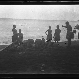 [Manum Island, New Guinea] Galip Nuts and Trays of Food in Leaf Bundles Waiting on the Beach to be Loaded onto the Canoes