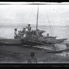 [Manum Island, New Guinea] Ladening up the Canoe with Baskets of Galips when the Canoe is Already Half in the Water