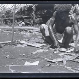 [Manum Island, New Guinea] A Near View of the way in which the Edge of the Sail is Finished off. This Man is Using a European Packing Needle