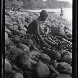 [Manum Island, New Guinea] Tsomoraua Having Finished her own Bath, Proceeds to Wash the Baby in Fresh Water Contained in a Coconut Shell