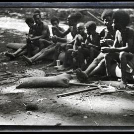 [Manum Island, New Guinea] Young Men and Boys Watching the Men Dig for Mwagum Roots at Mwanelauri's Place