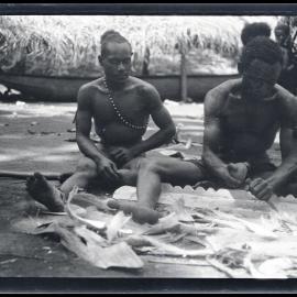 [Manum Island, New Guinea] Zabe Carving a Perapera Plank. ’Asu’asu Watching