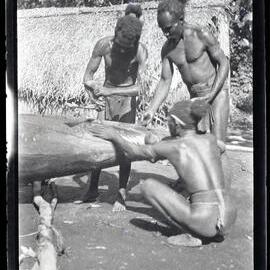 [Manum Island, New Guinea] Canoe Painting at Yabururu's. Three Elderly Men Painting the Prow of the Canoe