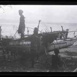 [Manum Island, New Guinea] Mamboti’s Canoe. Fastening the laŋolaŋo to the mwabwa