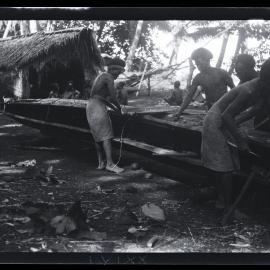 [Manum Island, New Guinea] Mamboti’s Canoe. Caulking the Joins Between the Washstrakes and Hull