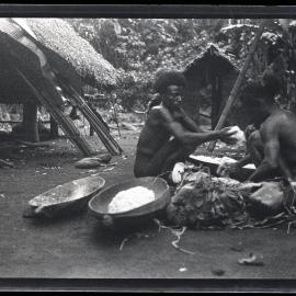 [Manum Island, New Guinea] Two Men Mixing the Sago and Grated Coconut