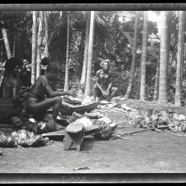 [Manum Island, New Guinea] Scraping Coconuts