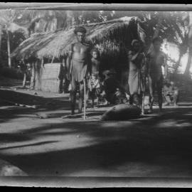 [Manum Island, New Guinea] In Mamboti’s Homestead. Fastening a Pig to the Ground