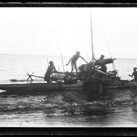 [Manum Island, New Guinea] Transferring a Pig to the Second Buonaputa Canoe which is Already Launched