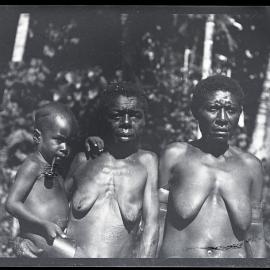 [Manum Island, New Guinea] Tsedam’s Two Wives, Morua and Tu’ura, with his Adopted Son Momai