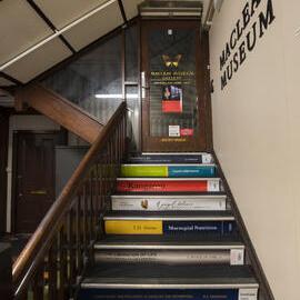 Stairs and Sign on Door to Macleay Museum Gallery