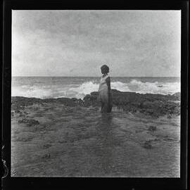 [Narau] A Woman Gathering Shellfish at the Edge of the Reef at Very Low Tide