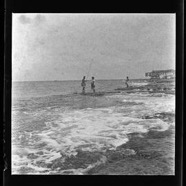 [Narau] A Man and Woman Fishing with Rod and Line at the very Edge of the Reef at Low Tide
