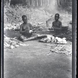 [Manum Island, New Guinea] Sagido and Kudsiri Scraping Taro (Brought by the Men of Yassa) and Cooking it