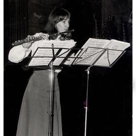 Frances Ford Playing the Flute in the Great Hall at the Annual Function of Convocation