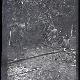 [Manum Island, New Guinea] ? Men and Child Inspecting where the Pig will be Prepared